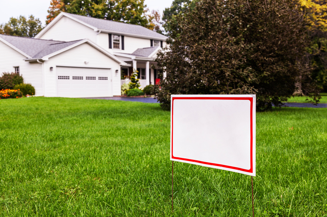 Blank Yard Sign On Suburban Home Front Lawn